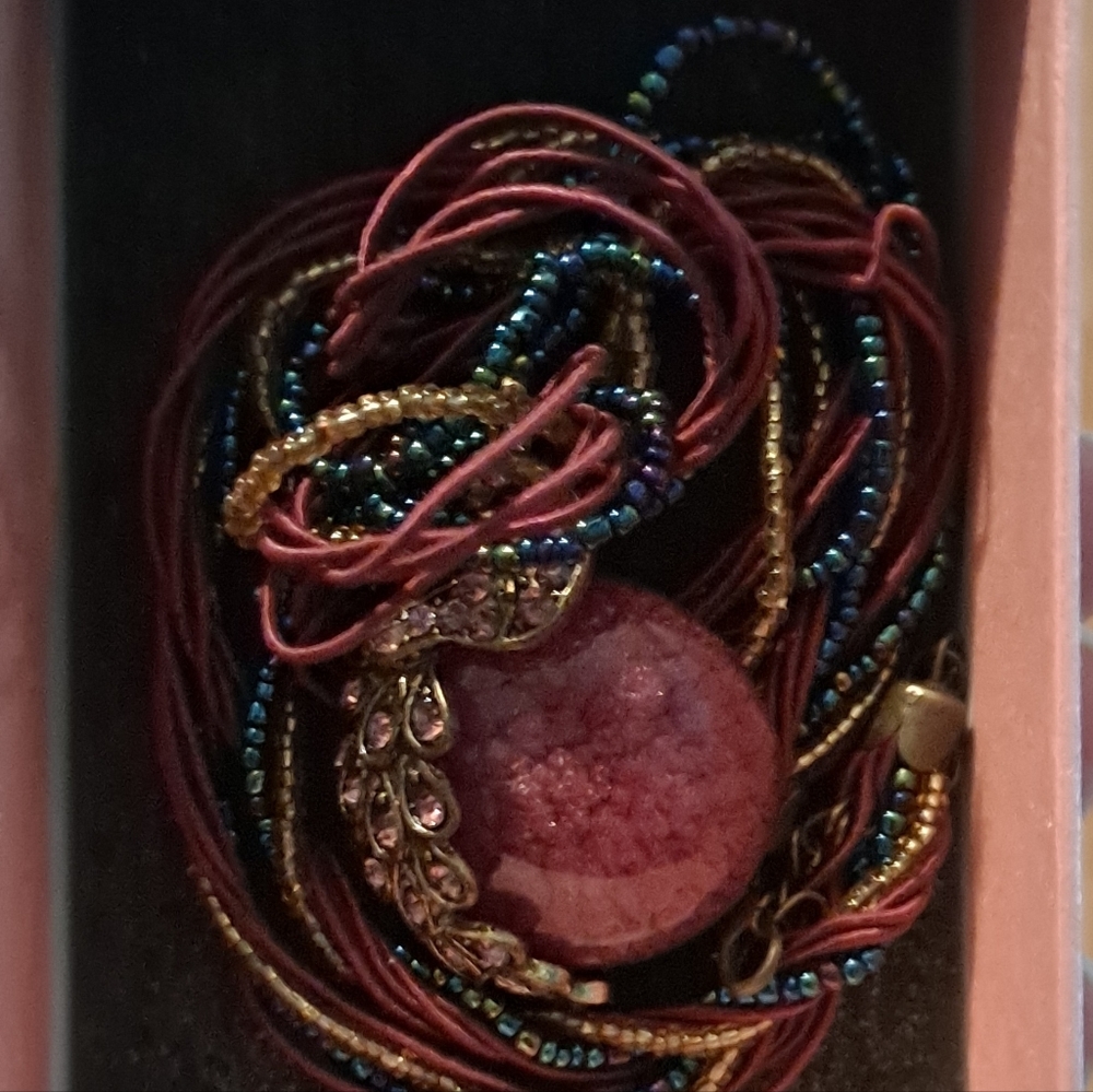 Multi string beaded/satin rope necklace with Peacock pendant